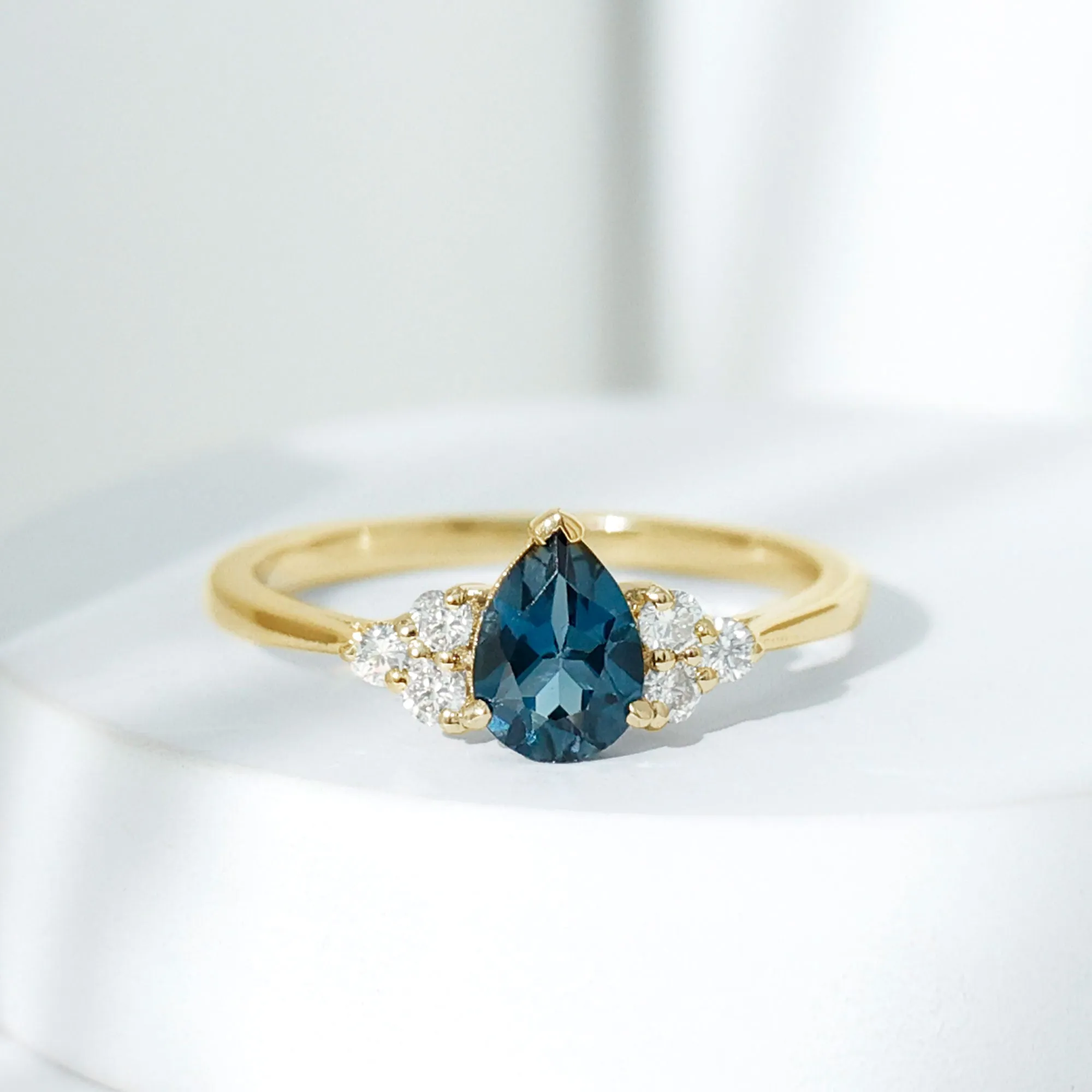 Pear Cut London Blue Topaz Engagement Ring with Diamond Trio